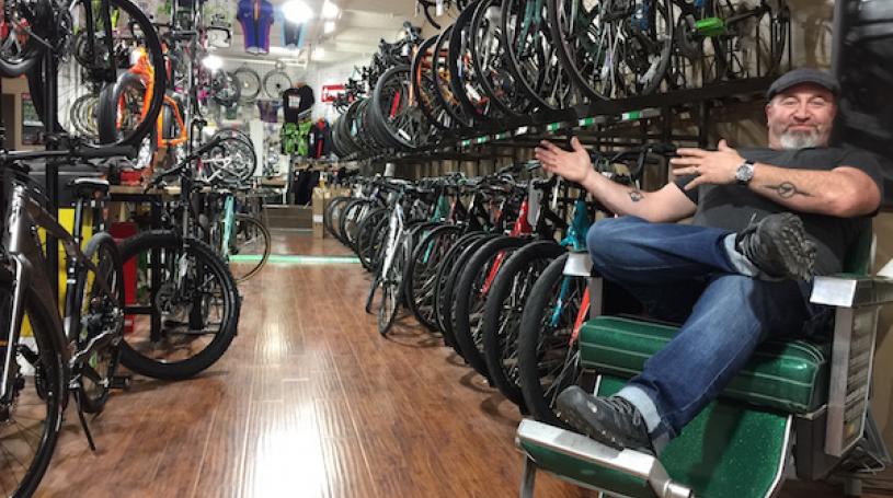 Zen Bikes owner John Keoshgerian surveys his store from the comfort of a recently restored barber chair. Photo by Scott Stiffler.