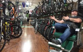 Zen Bikes owner John Keoshgerian surveys his store from the comfort of a recently restored barber chair. Photo by Scott Stiffler.